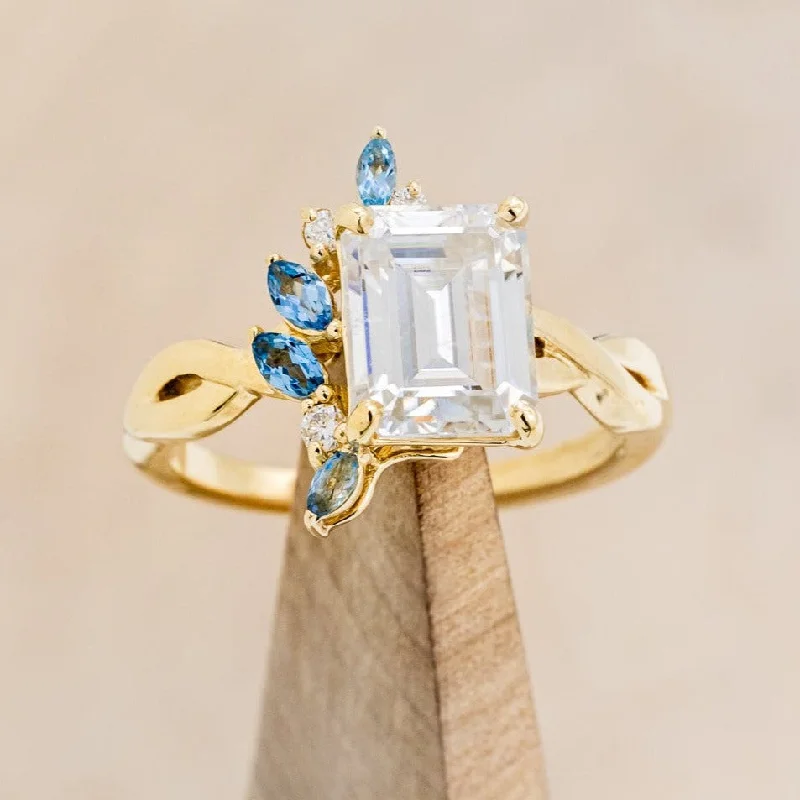 "GABRIELLA" - EMERALD CUT MOISSANITE ENGAGEMENT RING WITH AQUAMARINE ACCENTS IN A TWISTED BAND