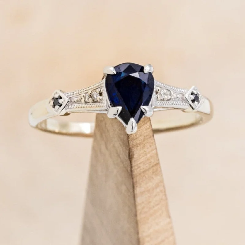 "ANNORA" - PEAR SHAPED LAB-GROWN BLUE SAPPHIRE ENGAGEMENT RING WITH BLACK & WHITE DIAMOND ACCENTS