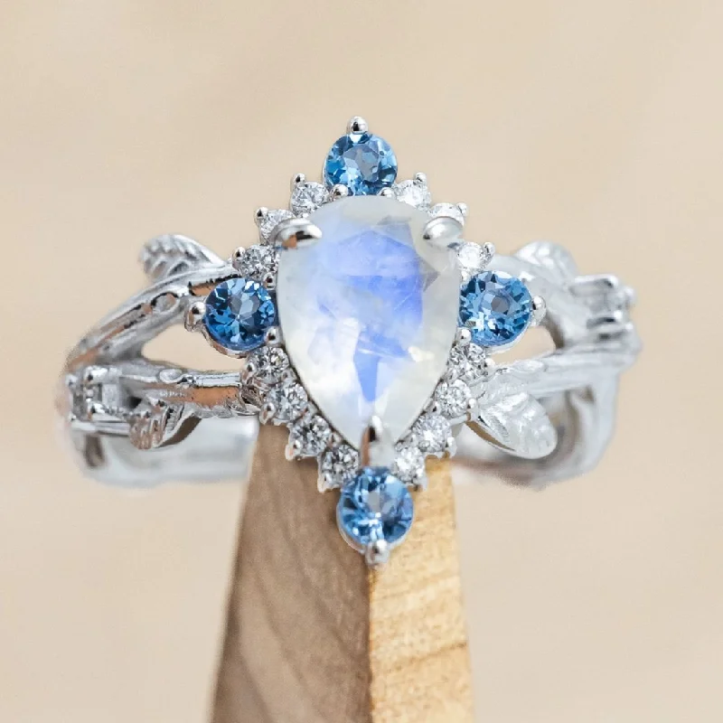 "ARTEMIS ON THE VINE DIVINE" - PEAR CUT MOONSTONE ENGAGEMENT RING WITH DIAMOND & AQUAMARINE ACCENTS IN A BRANCH-STYLE BAND